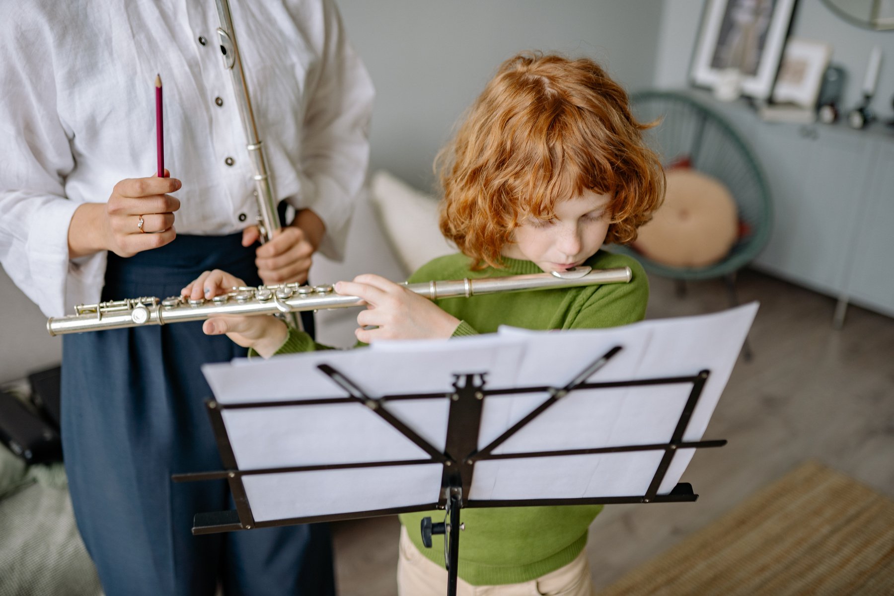 Boy Wearing Sweater Playing Flute